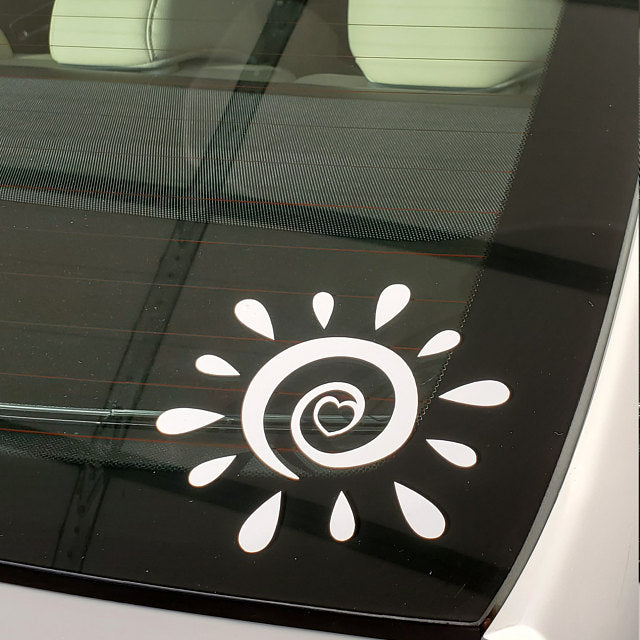 Swirly sun with a heart vinyl car window decal